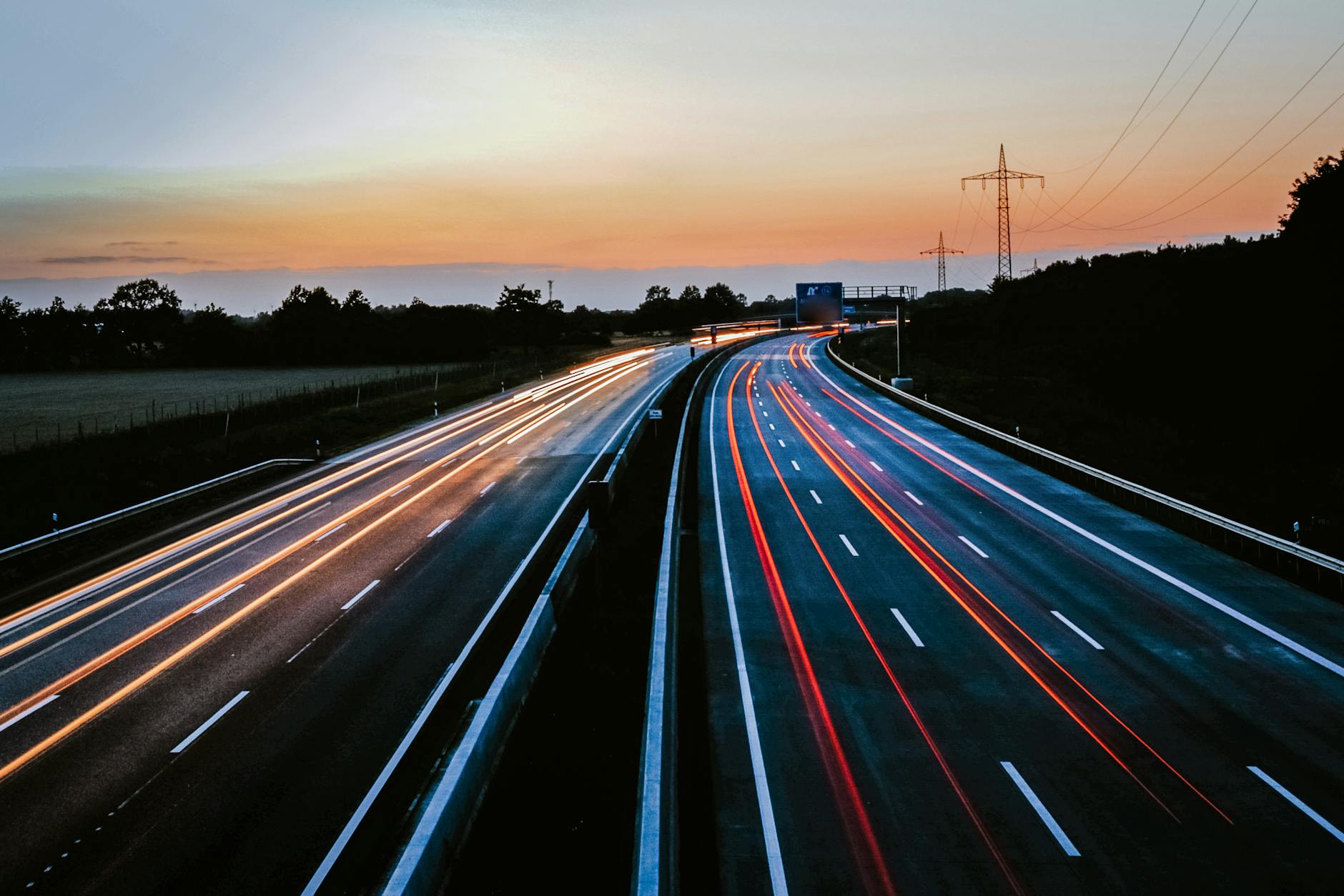 Świetlne smugi samochodów na ekspresówce o zmierzchu